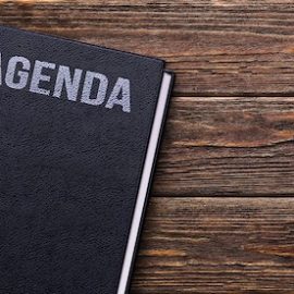 Photo of a book on a table with the words "Agenda"