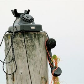 image of old style phone on a pole